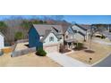 Aerial view of a two-story home with beautiful architecture, a driveway, and a green lawn at 4280 Hunters Walk Way, Cumming, GA 30028