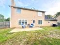 Home featuring a patio with outdoor seating and a spacious grassy backyard at 2586 Abbotts Glen Dr, Acworth, GA 30101