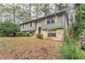 Split level home featuring an inviting facade with mature trees at 2897 Hedgewood Nw Dr, Atlanta, GA 30311