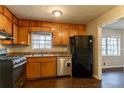 Kitchen area with ample wood cabinetry, gas range, and stainless steel appliances at 2897 Hedgewood Nw Dr, Atlanta, GA 30311