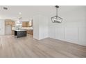 Open dining area with wainscotting, an elegant chandelier and hardwood flooring at 3555 New Hope Rd, Dacula, GA 30019