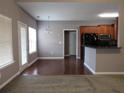 Open dining area showcasing hardwood floors adjacent to the modern kitchen space at 405 Clarion Dr, Carrollton, GA 30116