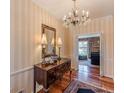 Elegant foyer featuring hardwood floors, chandelier, and a decorative mirror above a console table at 731 Pine Valley Rd, Mableton, GA 30126