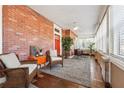 Inviting sunroom with brick walls, tile floors, and comfortable seating, perfect for relaxation at 1474 Athens Avenue Sw Ave, Atlanta, GA 30310