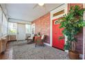 Charming sunroom featuring brick walls, a stained glass window, and comfortable seating at 1474 Athens Avenue Sw Ave, Atlanta, GA 30310