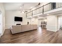Spacious living room with high ceilings, a fireplace, hardwood floors, and a large sectional sofa at 170 Charlotte Blvd, Stockbridge, GA 30281