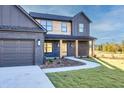Inviting two-story home showcasing a lovely front yard, a paved walkway, and a convenient two-car garage at 3567 New Hope Rd, Dacula, GA 30019
