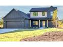 Charming two-story home featuring a well-manicured lawn, a two-car garage, and a welcoming front porch at 3567 New Hope Rd, Dacula, GA 30019