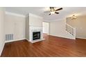 Open-concept living room with a fireplace and hardwood floors at 1381 Vintage Pointe Dr, Lawrenceville, GA 30044