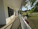 Wide porch with white railings offering scenic views of the neighborhood at 32 Ne Moriah Way, Rydal, GA 30171