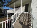 Elevated porch with white railings and wood steps providing outdoor enjoyment at 32 Ne Moriah Way, Rydal, GA 30171
