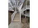Exterior staircase leading to the upper level with white railings and wood steps at 32 Ne Moriah Way, Rydal, GA 30171