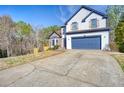 Charming two-story home with a blue garage door, lovely stone accents, and a well-manicured lawn at 340 Lazy Willow Ln, Lawrenceville, GA 30044