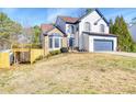 Charming two-story home with a blue garage door, lovely stone accents, and a well-manicured lawn at 340 Lazy Willow Ln, Lawrenceville, GA 30044