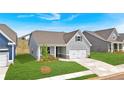 Desirable home with gray siding, an attached two-car garage, and a wonderfully manicured lawn at 61 Colonial Terrace, Villa Rica, GA 30180