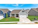 Attractive craftsman-style home featuring gray siding, a two-car garage, and a well-manicured lawn at 61 Colonial Terrace, Villa Rica, GA 30180