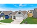Beautiful home with gray siding, an attached two-car garage, and a perfectly manicured lawn at 61 Colonial Terrace, Villa Rica, GA 30180