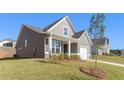 Side view of a gray home with white trim, showing the lawn, and a neatly landscaped yard at 71 Colonial Terrace, Villa Rica, GA 30180
