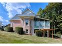 Back view of a brick home with an enclosed porch and a well-maintained lawn at 190 Winford Close, Duluth, GA 30097