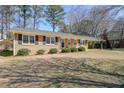 Traditional brick home with neatly trimmed shrubs and an attached carport at 773 Forest Ridge Se Dr, Marietta, GA 30067