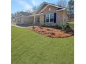 Beautifully landscaped front yard with a brick home, complemented by lush greenery and mulch at 5301 Tuscany Dr, Douglasville, GA 30135