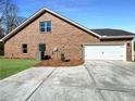 Brick home featuring a two-car garage and concrete driveway at 5321 Tuscany Dr, Douglasville, GA 30135