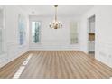 Bright and airy dining room with natural light and classic chandelier at 1536 Baxley Pine Trce, Suwanee, GA 30024