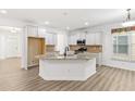 Open kitchen with granite countertops, white cabinets, and stainless steel appliances at 1536 Baxley Pine Trce, Suwanee, GA 30024