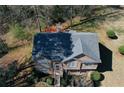 Aerial view of house showcasing backyard deck, manicured landscaping, and new roof at 1630 Versailles Dr, Atlanta, GA 30331