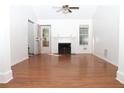 Bright living room features hardwood floors, fireplace, ceiling fan, and ample natural light at 1630 Versailles Dr, Atlanta, GA 30331