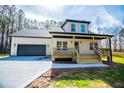 Attractive home featuring a welcoming front porch, modern design, and neat landscaping at 279 Laura Cir, Bowdon, GA 30108