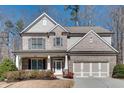 Beautiful two-story home with brick and siding, well-maintained landscaping, and attached garage at 5242 Park Vale Dr, Sugar Hill, GA 30518