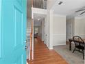 Inviting entryway with hardwood floors, staircase, and view into dining and living areas at 520 Ballyshannon Dr, Dacula, GA 30019