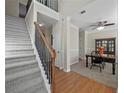 Welcoming foyer featuring a staircase with wood railing and views to the dining room at 520 Ballyshannon Dr, Dacula, GA 30019
