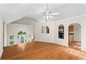 Open-concept layout with hardwood floors, high ceilings, kitchen access, and a view of the front entrance at 74 Rotunda Ct, Dallas, GA 30157