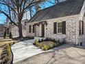A brick home features a new walkway and meticulous landscaping, showcasing its inviting entrance at 833 Martina Ne Dr, Atlanta, GA 30305