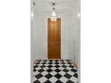 Elegant foyer features a black and white checkered floor and a striking crystal chandelier at 833 Martina Ne Dr, Atlanta, GA 30305
