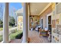 Inviting front porch with brick flooring, stone accents, and comfortable seating, perfect for relaxing outdoors at 2892 Darlington Run, Duluth, GA 30097