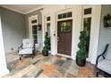 Welcoming front porch with decorative plants and inviting seating at 3045 Camp Branch Rd, Buford, GA 30519