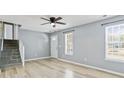 Bright and open living room with light-colored wood floors, ceiling fan, and natural light at 16 Vaughan Ne Dr, Cartersville, GA 30121