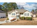 Charming home exterior with light-colored siding, green shutters, and a beautiful lawn at 1800 Rockdale Cir, Snellville, GA 30078