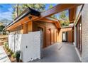 View of home showcasing its modern architectural style, a gated entrance, and a well-maintained lawn at 2751 Margaret Mitchell Nw Dr, Atlanta, GA 30327