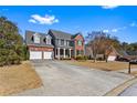 Beautiful brick home with a spacious driveway and well-manicured lawn at 935 Sunset Ridge Ln, Lawrenceville, GA 30045