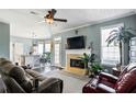 Inviting living room with a fireplace, large windows, and an open layout that flows into the kitchen at 935 Sunset Ridge Ln, Lawrenceville, GA 30045