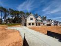 View of long concrete driveway to a new two-story house under construction at 1451 Stephens View Dr, Loganville, GA 30052