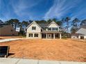 New construction two-story home featuring large front yard with sod in process at 1451 Stephens View Dr, Loganville, GA 30052