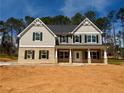 A stately two-story home with a charming covered front porch in a new community at 1451 Stephens View Dr, Loganville, GA 30052