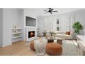 Inviting living room with a cozy fireplace, modern furniture, and large windows offering plenty of natural light at 245 Mayfair Ct, Alpharetta, GA 30009
