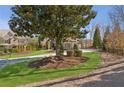 Charming home with meticulously maintained lawn, professional landscaping, and mature trees at 5640 Copper Creek Pass, Cumming, GA 30040