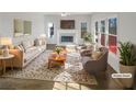 Bright living room showcasing neutral colors, a cozy fireplace, and lots of natural light from large windows at 6719 Winterberry Ridge Dr, Stone Mountain, GA 30087